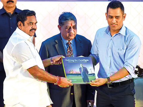 Tamil Nadu CM K Palaniswami (left) presents to Dhoni a coffee-table book on the journey of India Cements Ltd and 50 years of company’s association with MD N Srinivasan (centre).