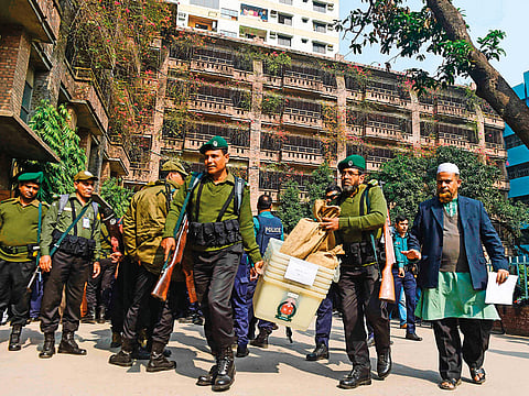Troops carry polling equipment in Dhaka yesterday. Bangladesh stepped up security during an election expected to see Prime Minister Sheikh Hasina win a record fourth term.