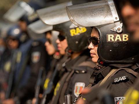 Bangladesh police's elite Rapid Action Battalion (RAB) women personnel guard a street on the eve of the general elections in Dhaka, Bangladesh, Saturday, Dec. 29, 2018.