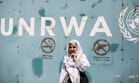 An elderly female stands outside the UN Relief and Works Agency office in Gaza