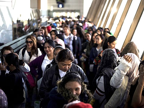 Filipina workers returning home from Kuwait arrive at Manila International Airport.