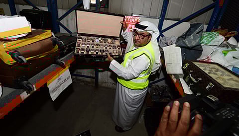 Ebrahim Behzad displays a batch of fake luxury watches confiscated in 2017. Shoes, bags, cosmetics, smartphones and accessories were the most common fake products seized.