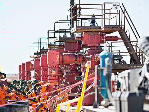 Six Chevron Corp oil wells being readied for hydraulic fracturing stand in the Permian Basin near Midland, Texas.  Both companies on Friday outlined deep cuts in investments in the Permian shale basin.