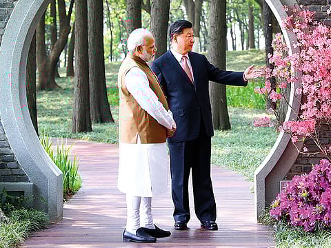 Modi and Xi Jinping take a walk in a garden in Wuhan in central China’s Hubei Province (File)