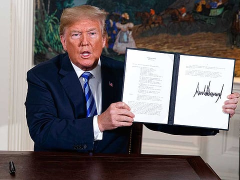 President Donald Trump shows a signed Presidential Memorandum after delivering a statement on the Iran nuclear deal. Trump announced the U.S. will pull out of the landmark nuclear accord with Iran, dealing a profound blow to U.S. allies and potentially deepening the president's isolation on the world stage.