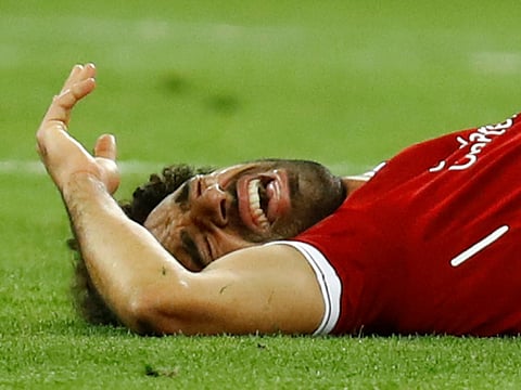 Liverpool's Mohammad Salah reacts after sustaining an injury during the Champions League Final against Real Madrid