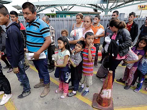 Immigrant families line up to enter the central bus station after they were processed and released by U.S. Customs and Border Protection in McAllen, Texas.