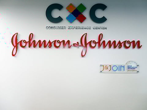 The logo of US multinational medical devices and pharmaceutical company Johnson & Johnson at the entrance of the research and development plant, in Val-de-Reuil, northwestern France.