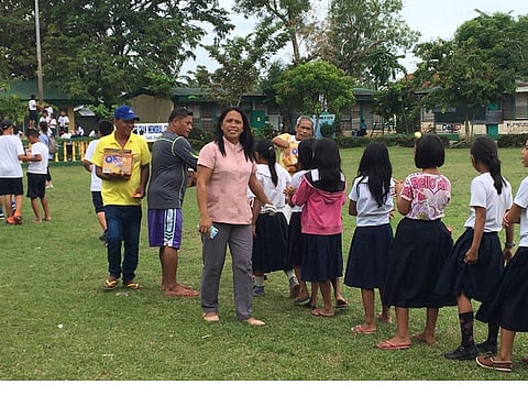 Charie Loreno Arieta, centre, a public school teacher in the Philippines.