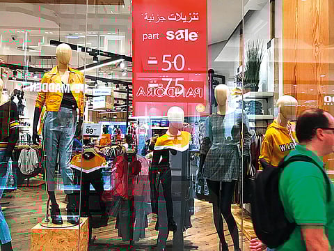 A sale sign in the window of a shopping outlet. For illustrative purposes only.