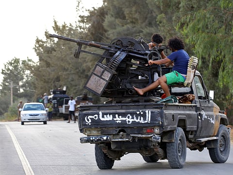 Libyan militiamen loyal to the Government of National Accord (GNA), Libya's internationally recognised government, keep watch from a position south of the Libyan capital Tripoli on September 25, 2018.