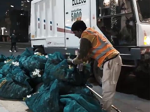 A worker cleans up after the New Year's Eve celebrations in Downtown Dubai.
