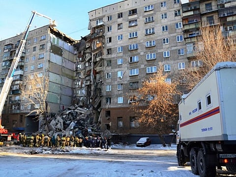 Russian Emergencies Ministry members work at the site of a partially collapsed apartment block in Magnitogorsk, Russia December 31, 2018