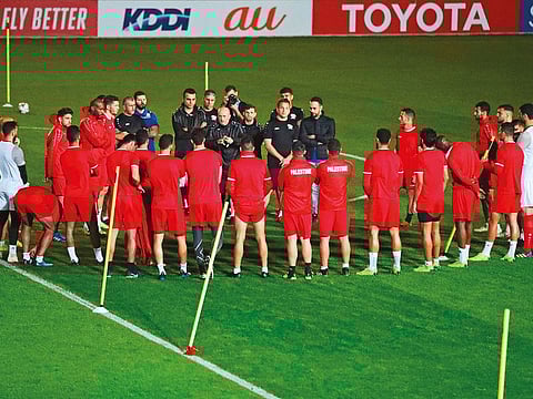 Palestine players listen to their coach Noureddine Ould Ali during a training session in Sharjah on Saturday.