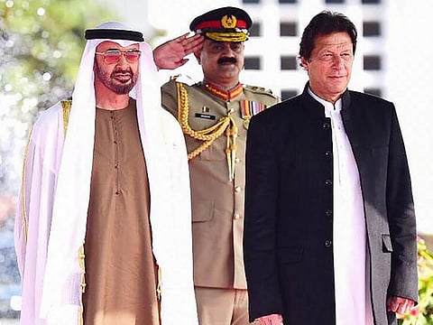 File image from 2019: Sheikh Mohamed Bin Zayed Al Nahyan attends a welcoming ceremony next to Imran Khan (right) at the Prime Minister House in Islamabad in 2019.