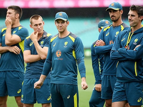 Australia's captain Tim Paine (C) watches on with teammates as India celebrates the victory at the SCG in Sydney, on January 7, 2019.