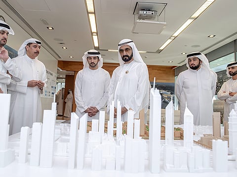 Shaikh Mohammad views a scale model of the DIFC 2.0 as Shaikh Hamdan Bin Mohammad Bin Rashid Al Maktoum, Crown Prince of Dubai; Shaikh Maktoum Bin Mohammad Bin Rashid Al Maktoum, Deputy Ruler of Dubai; Shaikh Ahmad Bin Mohammad Bin Rashid Al Maktoum, Vice- Chairman of Dubai 2020 Work Group; Shaikh Mansour Bin Mohammad Bin Rashid Al Maktoum, President of Dubai International Marine Club and Eisa Kazim, DIFC Governor, look on.