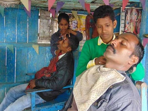 Sisters handling male customers at their gent’s salon in the shop.
