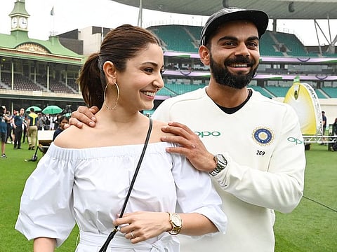 Virat Kolhi and his wife Anushka Sharma walk on the field as they celebrate India's series win on the fifth day of the fourth and final cricket Test against Australia at the Sydney Cricket Ground in Sydney on January 7, 2019.