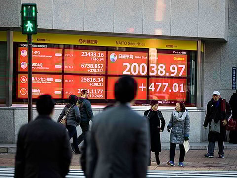 File picture of a stock indicator board at Tokyo Stock Exchange. Global stocks, and more so Asia's, have been in a free fall as investors fret about economic growth and corporate losses.