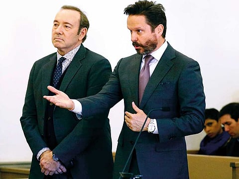 Kevin Spacey stands in district court as his attorney Alan Jackson addresses the judge during arraignment on a charge of indecent assault and battery