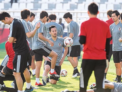Japan captain Maya Yoshida (centre) attends a training session on the eve of their match against Turkmenistan in Abu Dhabi on Tuesday.