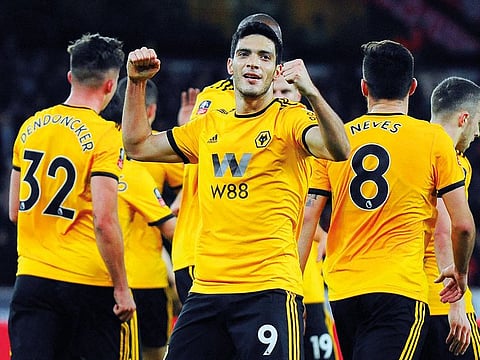 Raul Jimenez celebrates after scoring Wolverhampton’s first goal during the English FA Cup third round match against Liverpool at Molineux Stadium on Monday. The wolves won 2-1.