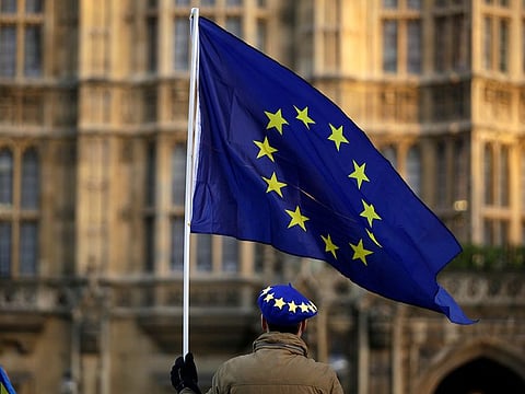 A pro-Europe demonstrator holds a flag outside the Houses of Parliament in London, Tuesday Jan. 8, 2019.