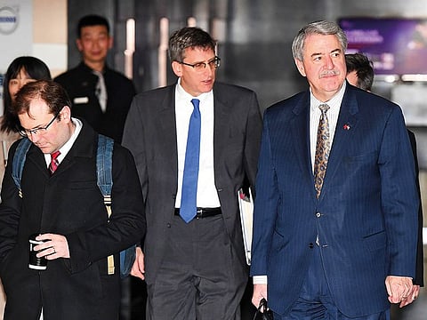 US Undersecretary for Trade and Foreign Agricultural Affairs Ted McKinney (right), part of a US government delegation, leaves a hotel for the second day of trade talks in Beijing on Tuesday.