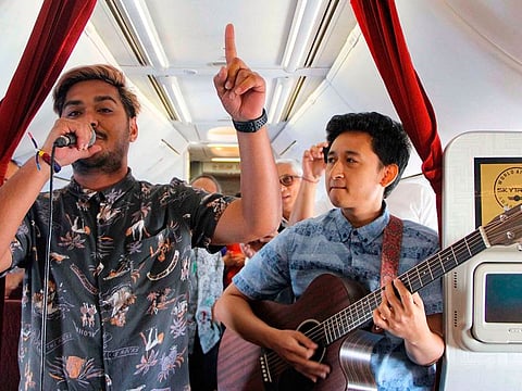 This handout from Garuda Indonesia taken and released on January 9, 2019 shows musicians performing on a flight from Jakarta to Bali. Indonesian national flag carrier Garuda has announced it will be bringing music to the skies with a series of live acoustic concerts on domestic flights.