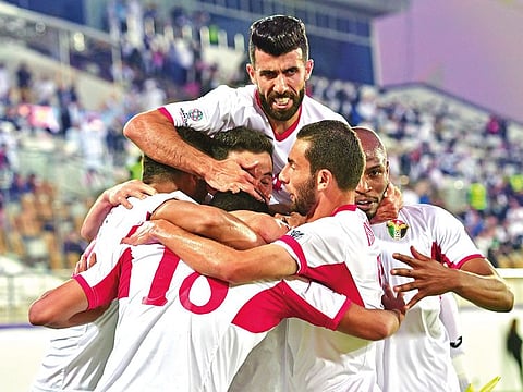 Jordan's players celebrate their opening goal during the 2019 AFC Asian Cup group B football match between Jordan and Syria at the Khalifa bin Zayed stadium in Al Ain on January 10, 2019.