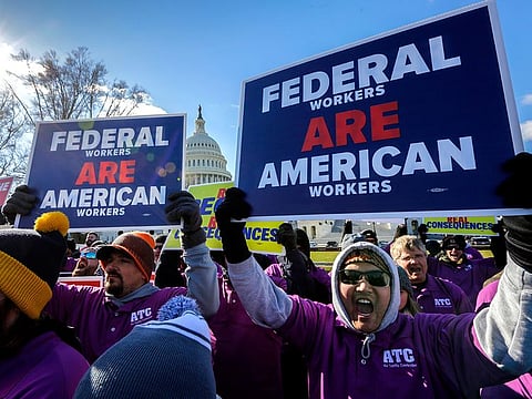 On the 20th day of a partial government shutdown, federal employees rally at the Capitol to protest the impasse between Congress and President Donald Trump over his demand to fund a U.S.-Mexico border wall, in Washington, Thursday, Jan. 10, 2019.