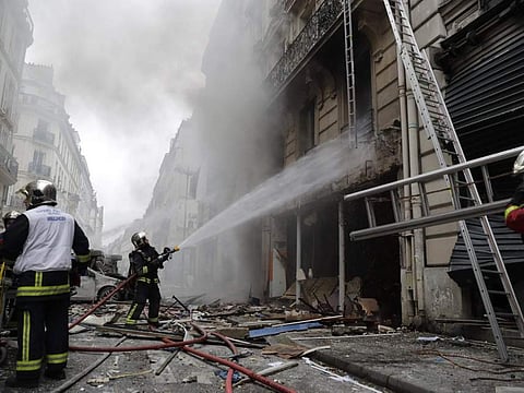 Emergency workers and firefighters work at the scene after the explosion in Paris ( AFP/Getty Images )