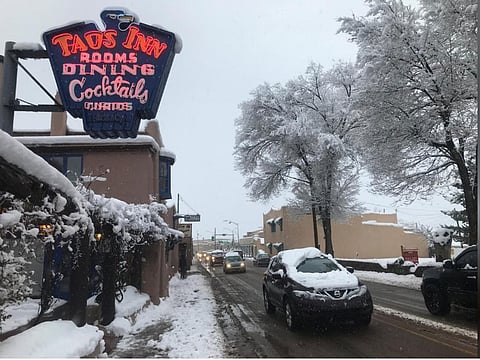 Traffic moved through the town centre after a major winter storm dropped around 8 inches of snow in Taos, New Mexico, US, on January 11, 2019.