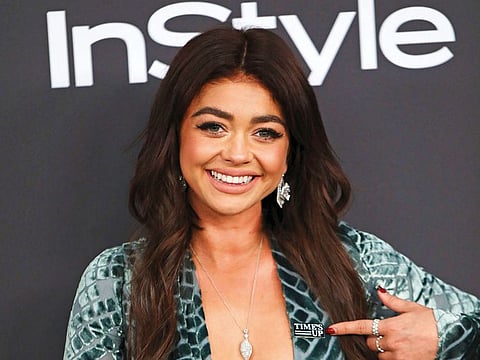 Sarah Hyland points to a Time’s Up pin as she arrives at the InStyle and Warner Bros Golden Globes after party on January 6.