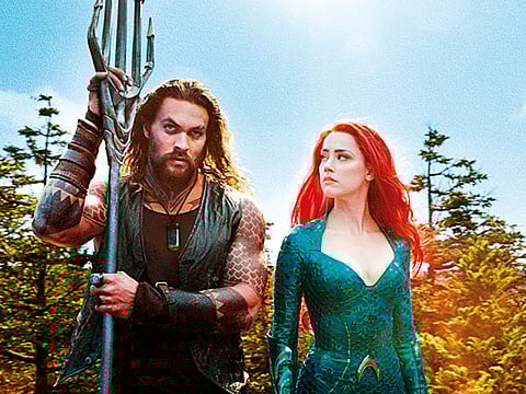 Jason Momoa, left, and Amber Heard in a scene from "Aquaman."