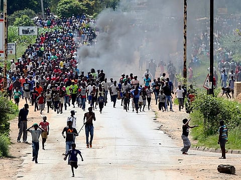 Protestors gather on the streets during demonstrations over the hike in fuel prices in Harare, Zimbabwe, Monday, Jan. 14, 2019.