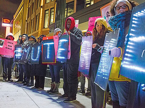 Protesters with signs spelling ‘Mute R Kelly’ before an R Kelly concert in 2017.