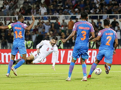 India's midfielder Pronay Halder (1st-left) fouls Bahrain's defender Hamad Alshamsan (2nd-left) during the 2019 AFC Asian Cup group A football match between India and Bahrain at the Sharjah Stadium in Sharjah on January 14, 2019.