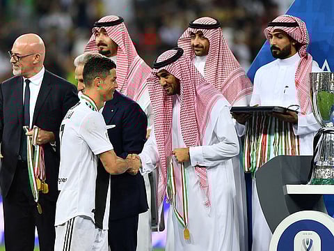 Juventus' Cristiano Ronaldo receives a medal after winning the Italian Super Cup.