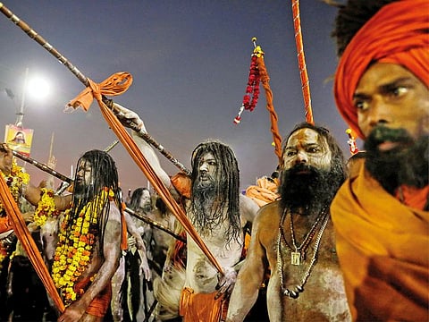 Naga Sadhus or Hindu holy men arrive to take a dip during the first "Shahi Snan" (grand bath) during "Kumbh Mela" or the Pitcher Festival, in Prayagraj, previously known as Allahabad, India.