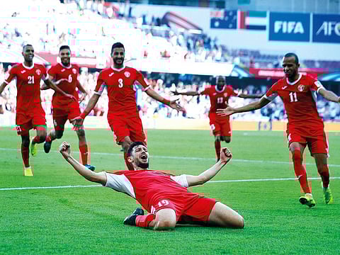 Jordan's defender Anas Bani Yaseen, front, celebrates with teammates after scoring the opening goal during the AFC Asian Cup group B soccer match between Australia and Jordan at Hazza bin Zayed stadium in Al Ain, United Arab Emirates, Sunday, January 6, 2019.