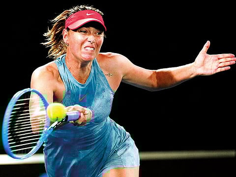 Russia's Maria Sharapova hits a forehand return to Denmark's Caroline Wozniacki during their third round match at the Australian Open tennis championships in Melbourne, Australia, on Friday, January 18, 2019.