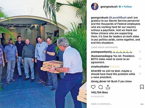Bush, right, delivers pizzas to his secret service detail in Florida