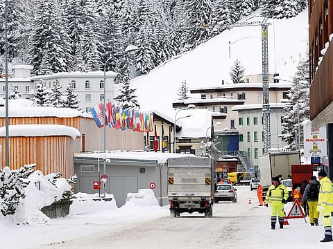 Flags fly in front of the congress centre, the venue of the World Economic Forum (WEF) in Davos, Switzerland. The summit formally begins on Tuesday.