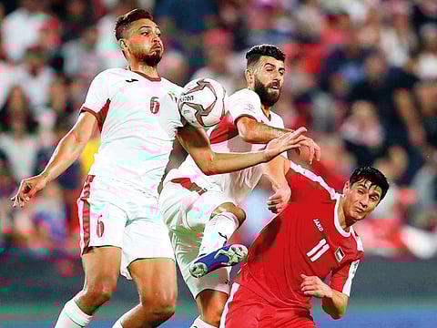 Jordan’s Baha Abdul Rahman and Saeed Al Murjan battle with Palestine’s Yashir Pinto during a Group B match in Abu Dhabi last week.