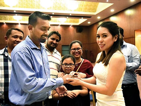 Indian Desmond Donald Coelho and Filipina Pacita Olita Felicilda exchange marriage vows at the Indian Consulate after six years of courtship.