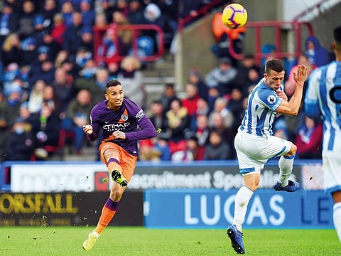Manchester City’s defender Danilo shoots past Huddersfield Town’s midfielder Jonathan Hogg during the Premier League match at the John Smith’s stadium in Huddersfield