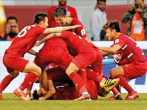 Vietnam players celebrates after their win over Jordan in the Round of 16 match of the Asian Cup at Al Maktoum Stadium