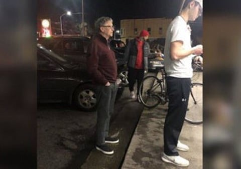 Bill Gates waits in line to get a burger.